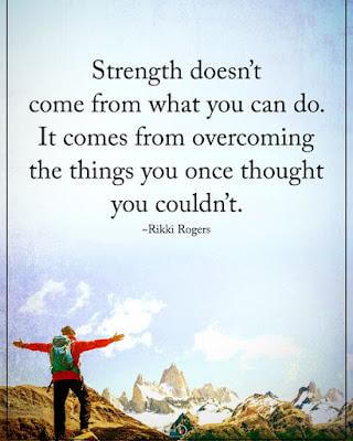 Person with arms raised on mountain peak with motivational quote