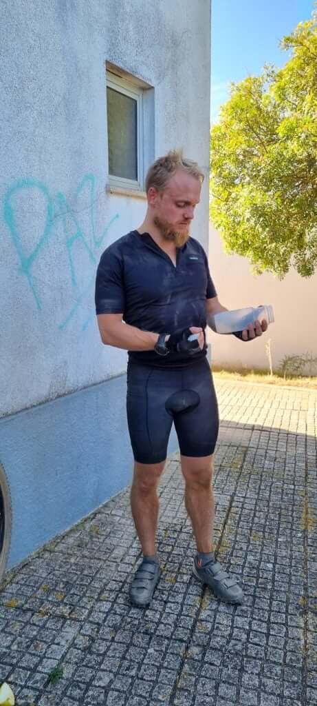 Standing against white wall before race